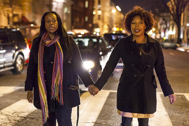 Demonstrators blocked roads in Washington D.C.	Photo credit: © Samuel Corum/Anadolu Agency/Getty Images Women hold hands outside