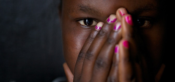 Female with hands covering her face