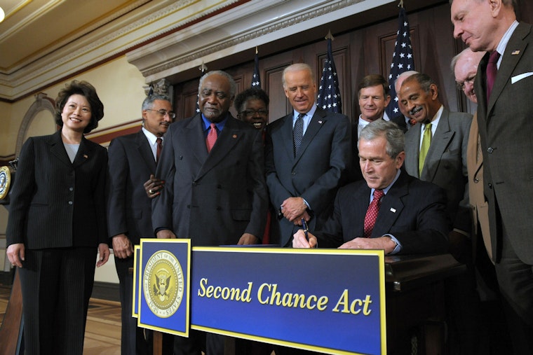 President George W. Bush surrounded by advocates and lawmakers
