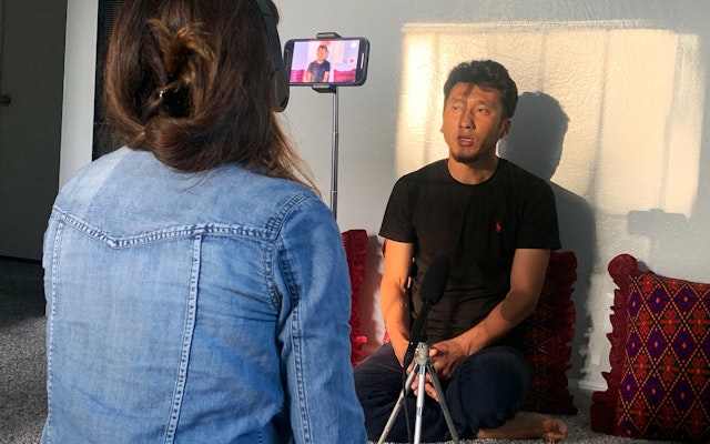 An interviewer recording a participant