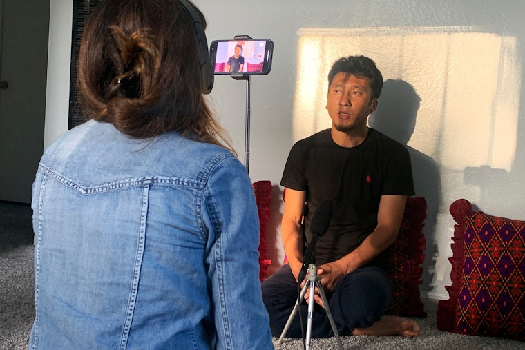 An interviewer recording a participant