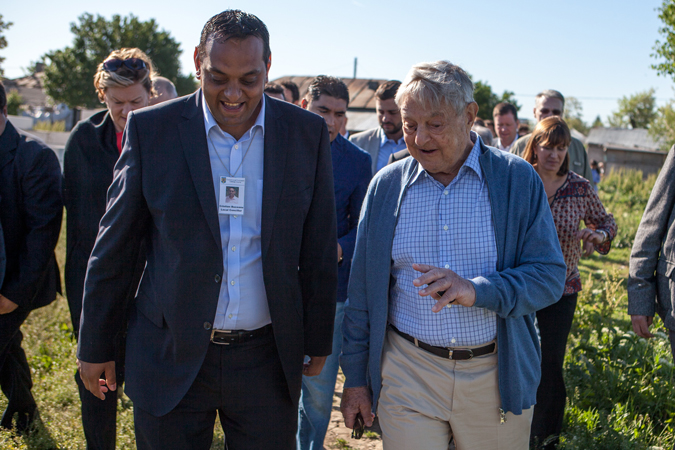 Two men walk together.