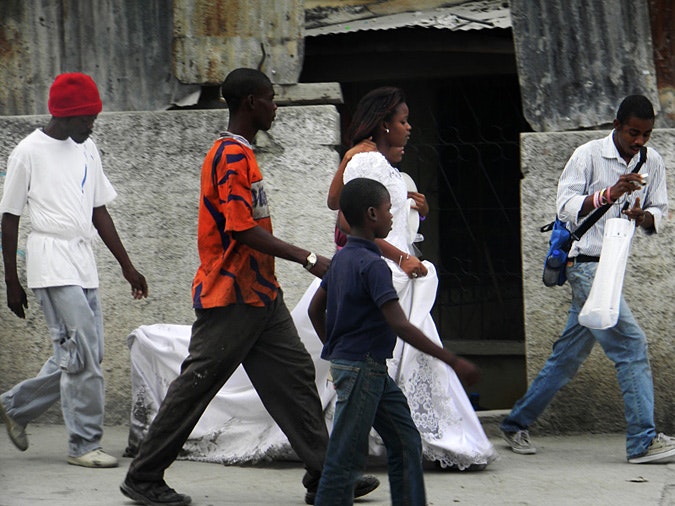 Betty Laurent walks down street in wedding gown