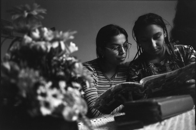 Two girls looking at a book
