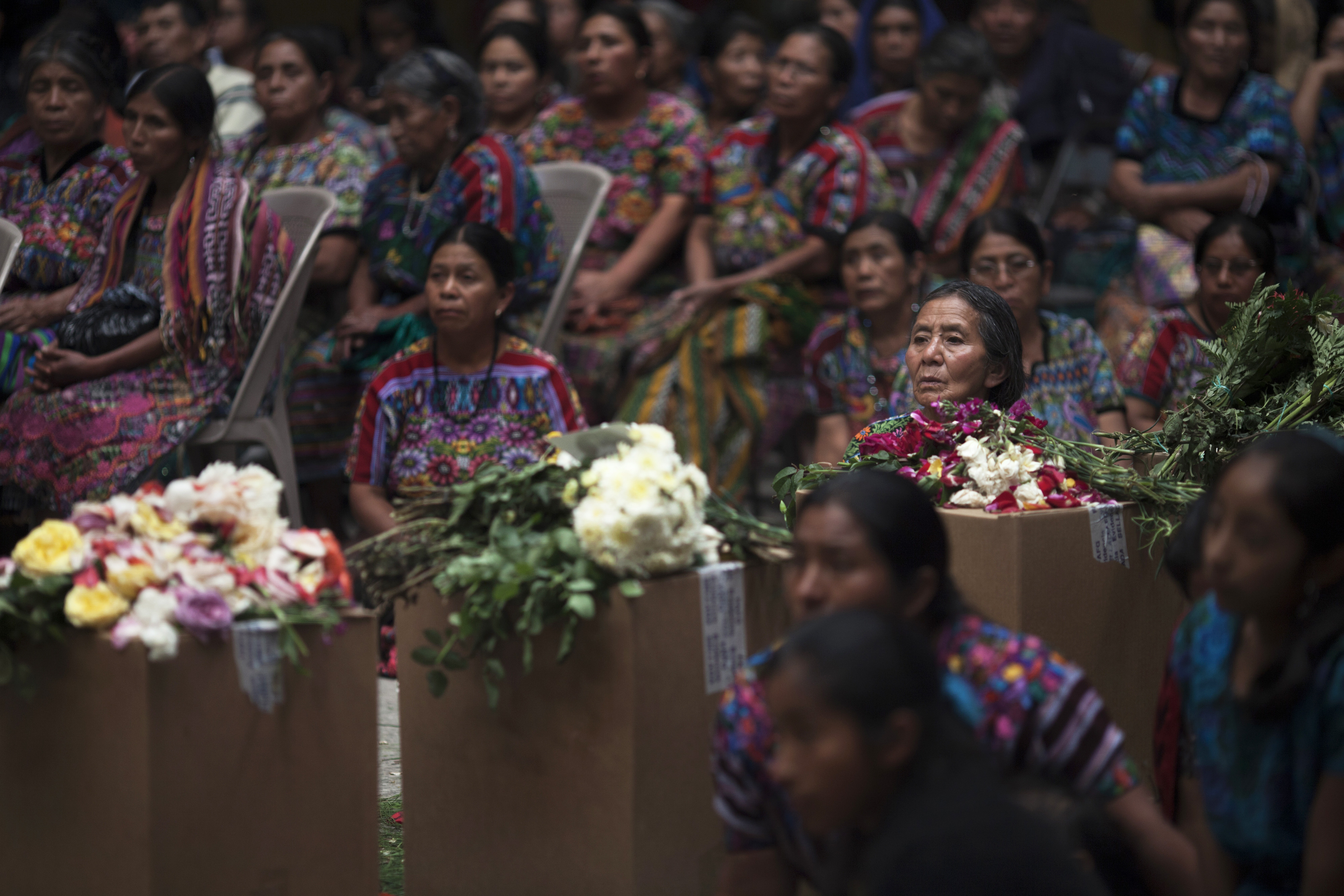 Large group of women with boxed remains