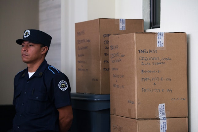 A police officer standing in front of boxes