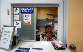 A man at a medical clinic window