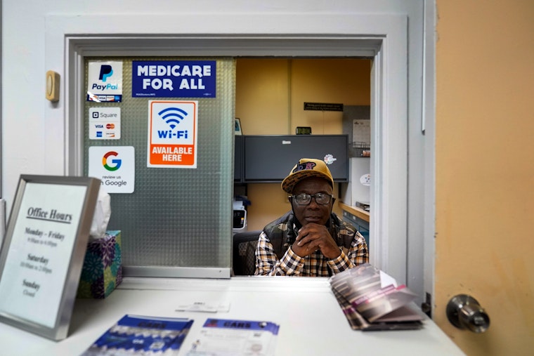 A man at a medical clinic window