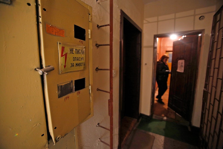 An electricity box in front of a doorway.