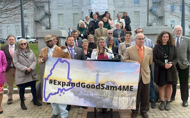 Harm reduction advocates speak after a meeting to expand Maine’s Good Samaritan law in April 2022. Photo courtesy of the Maine Recovery Advocacy Project A group of people stand in front of a government
