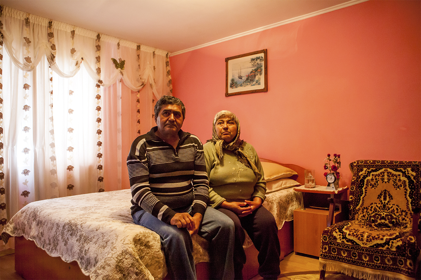 Couple sits in bedroom