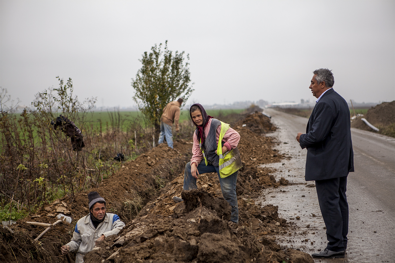 Woman carries buckets in the street