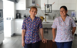 Two women standing in a kitchen