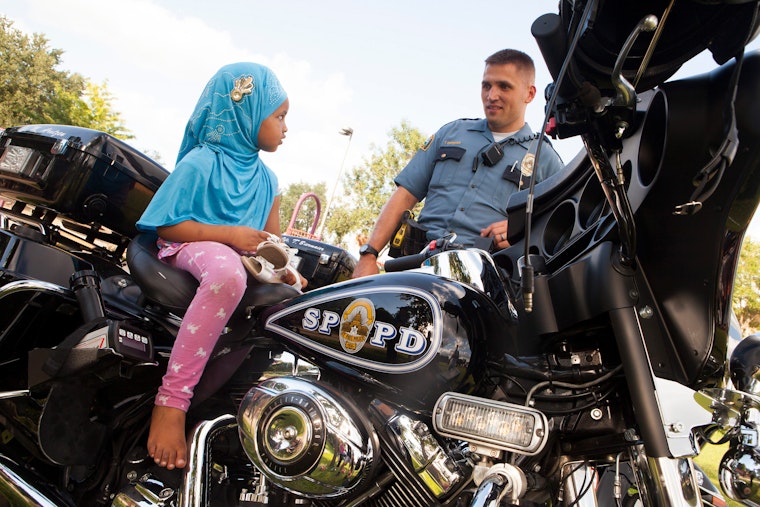 A girl sits on a police motocycle