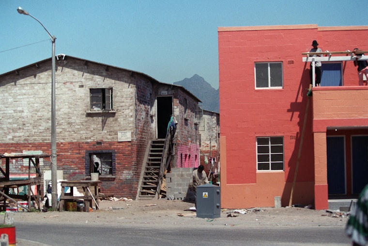 A renovated hostel in South Africa stands beside another in its original state. Photo credit: © Siphiwe Sibeko for the Open Society Foundations A renovated hostel next to an old one
