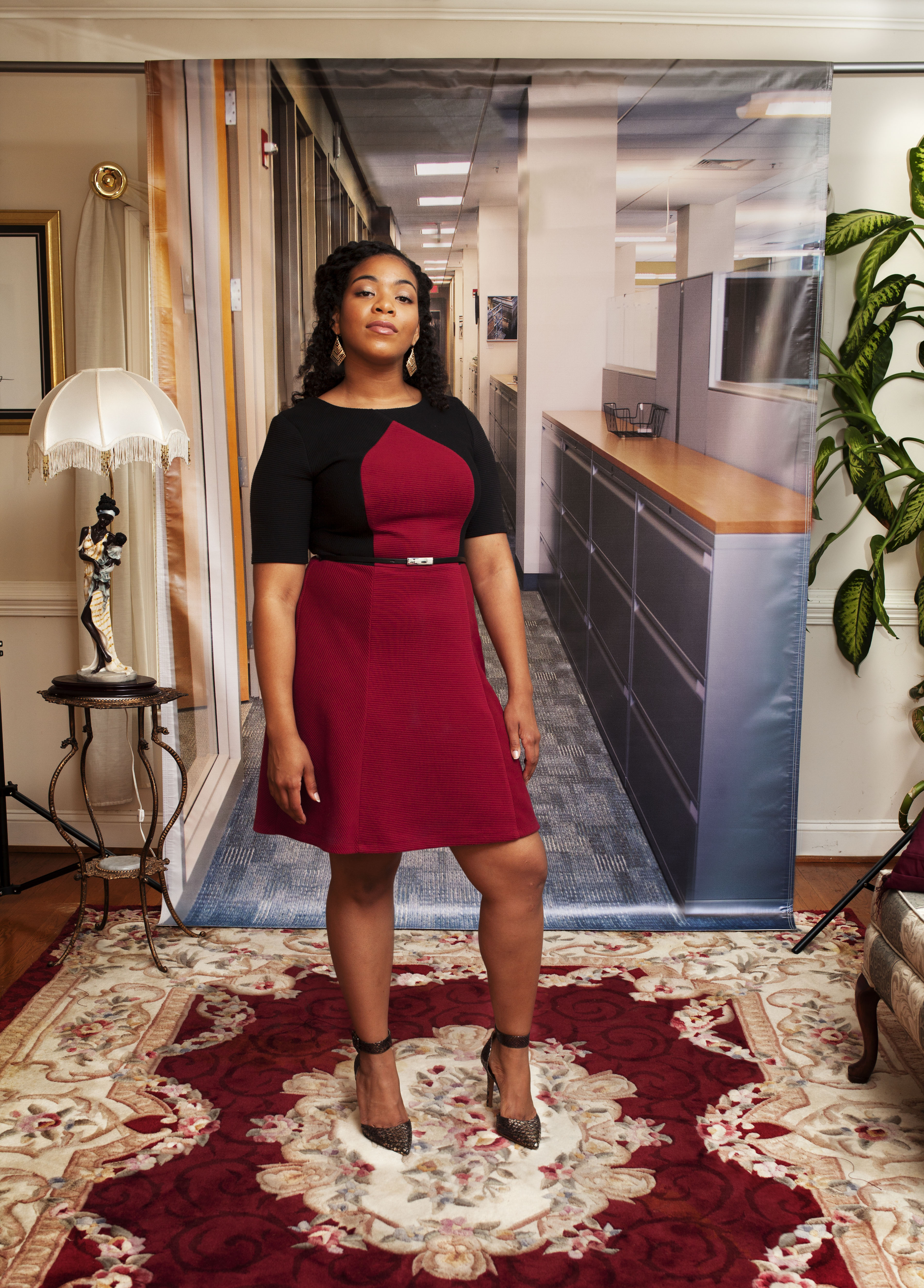 A woman standing in front of a backdrop