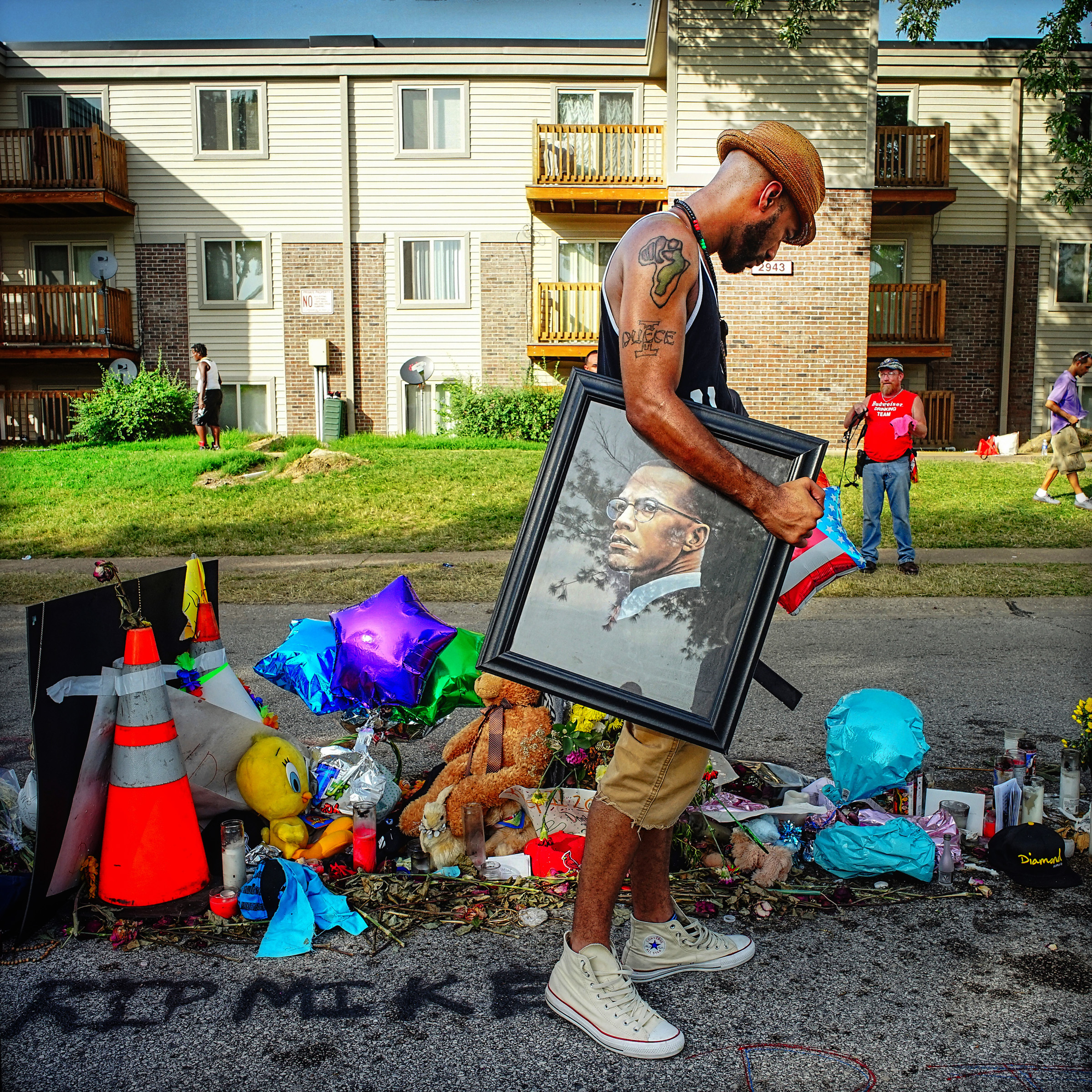 A man looks at a momentos on a sidewalk