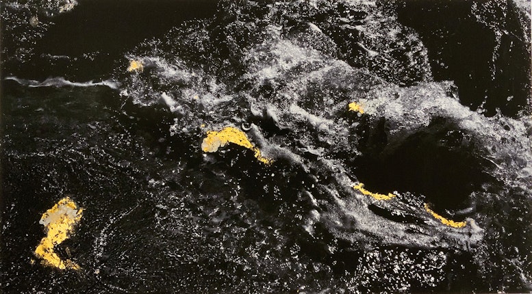 Black and white image of water with collaged gold leaf.