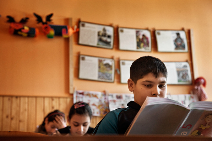 A school room with a boy reading