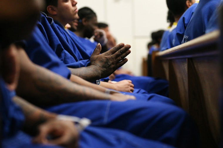 Christmas Mass is held in a chapel at Men's Central Jail, in Los Angeles, California, on December 25, 2019. Photo credit: © Mario Tama/Getty A group of male inmates pray