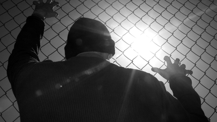 Still image from “What’s at Stake at UNGASS 2016.” The effort to eliminate all drug production and impose a zero tolerance approach to drug use didn’t work. In fact, these efforts have done more harm than good the world over. Man against a chain-link fence