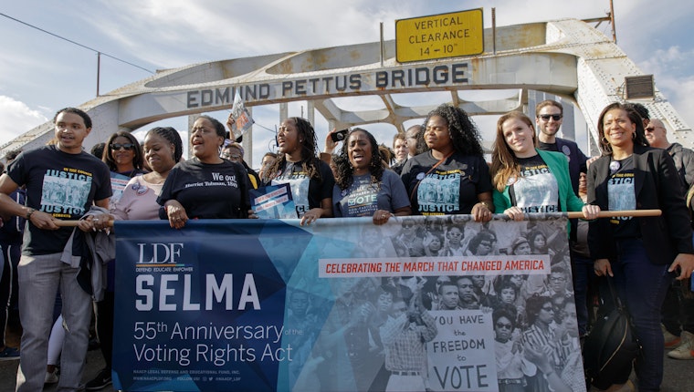 Leaders and staff from the NAACP Legal Defense and Education Fund commemorate the 1965 Selma to Montgomery March in Selma, Alabama, on March 1, 2020. Photo credit: © Matthew Stover for LDF People holding a sign commemorating the 55th anniversary of the Voting Rights Act