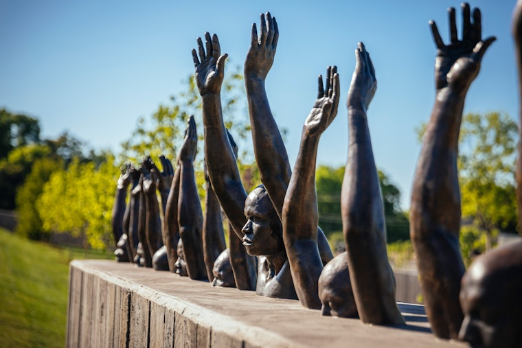 A sculpture by Hank Willis Thomas, dedicated to the victims of white supremacy, stands on the grounds of the National Memorial for Peace and Justice, in Montgomery, Alabama, on April 20, 2018. Photo credit: © Audra Melton/NYTimes/Redux A sculpture depicting a group of Black men with their hands up