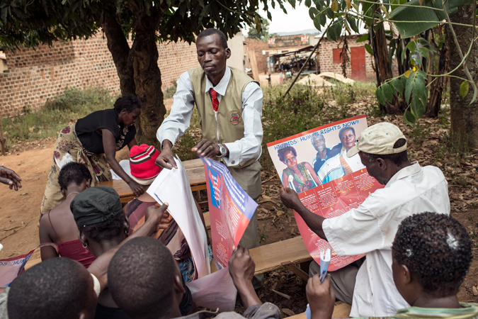 A man handing out posters
