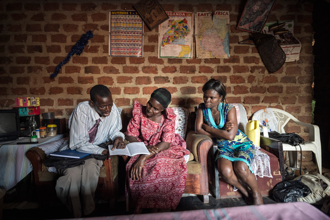 A man shows two women a document