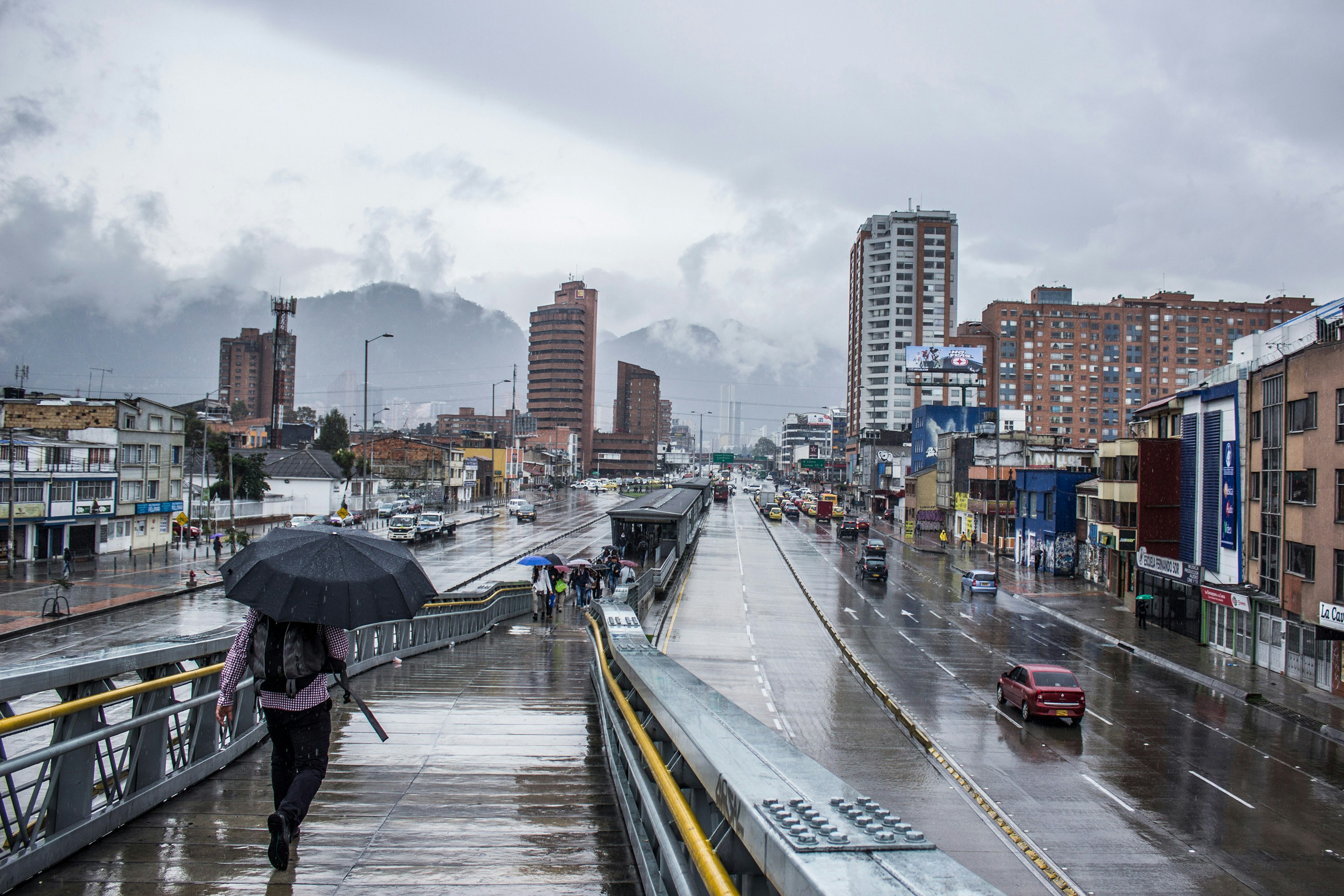 A person walking with an umbrella in Bogota, Colombia.