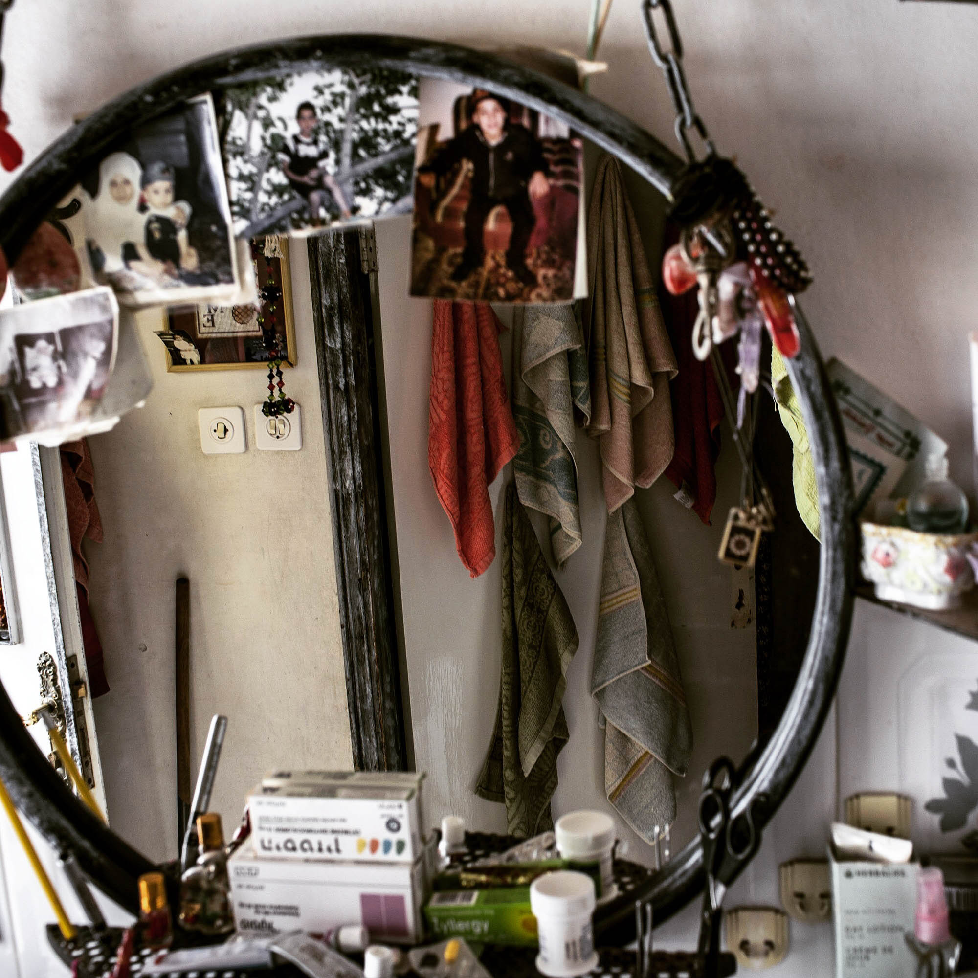 A bedroom mirror reflecting a bath towels