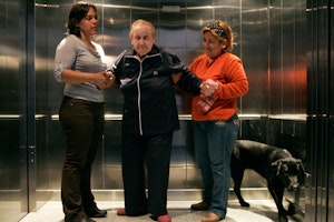 A doctor and a relative help a patient off an elevator