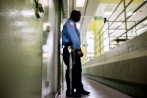 A prison guard outside jail cells