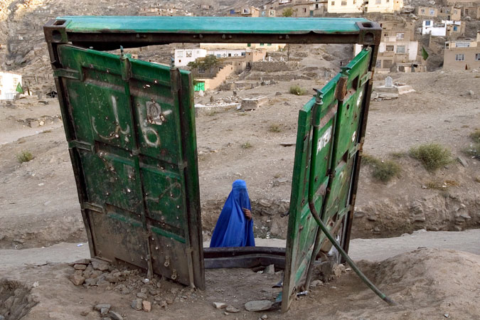 Woman walking past container doors.