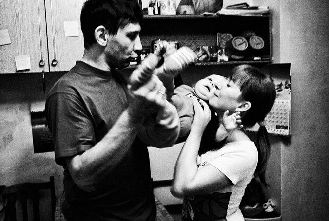 Man and woman playing with a baby