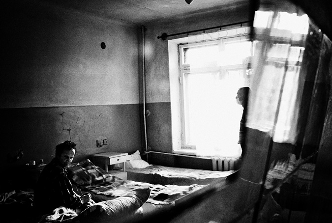 TB patient sitting on a bed