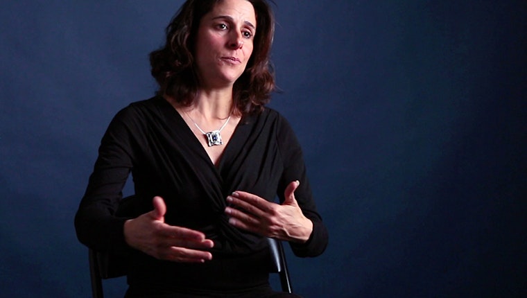Still image from “An Israeli Group Helps Palestinians Find Freedom.” Gisha is an Israeli human rights organization that promotes the right to freedom of movement. They provide legal assistance to people in Gaza who need permits from the Israeli military in order to travel. They also engage in public advocacy, within Israel and abroad, to try to change policies that restrict freedom of movement but that don’t involve legitimate security needs. Sari Bashi