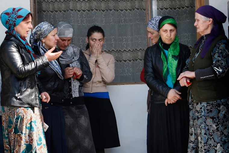 Relatives and neighbors gather outside a home in the Pankisi Gorge region of Georgia, shortly after two of their village’s teenagers left to join ISIS. Photo credit: © Shakh Aivazov/Corbis A group of women standing outside a home
