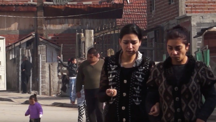 Still image from “The Others.” A series of four documentary movies focus on Roma whose homes were demolished, and the high-ranking officials complicit in the evictions. Two women walking along a street