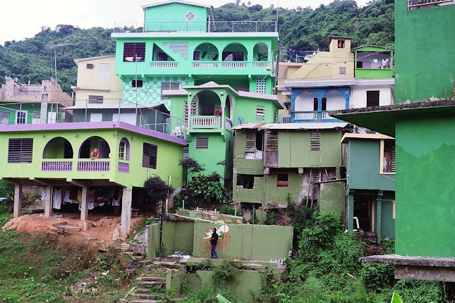 A landscape view of homes painted different shades of green.