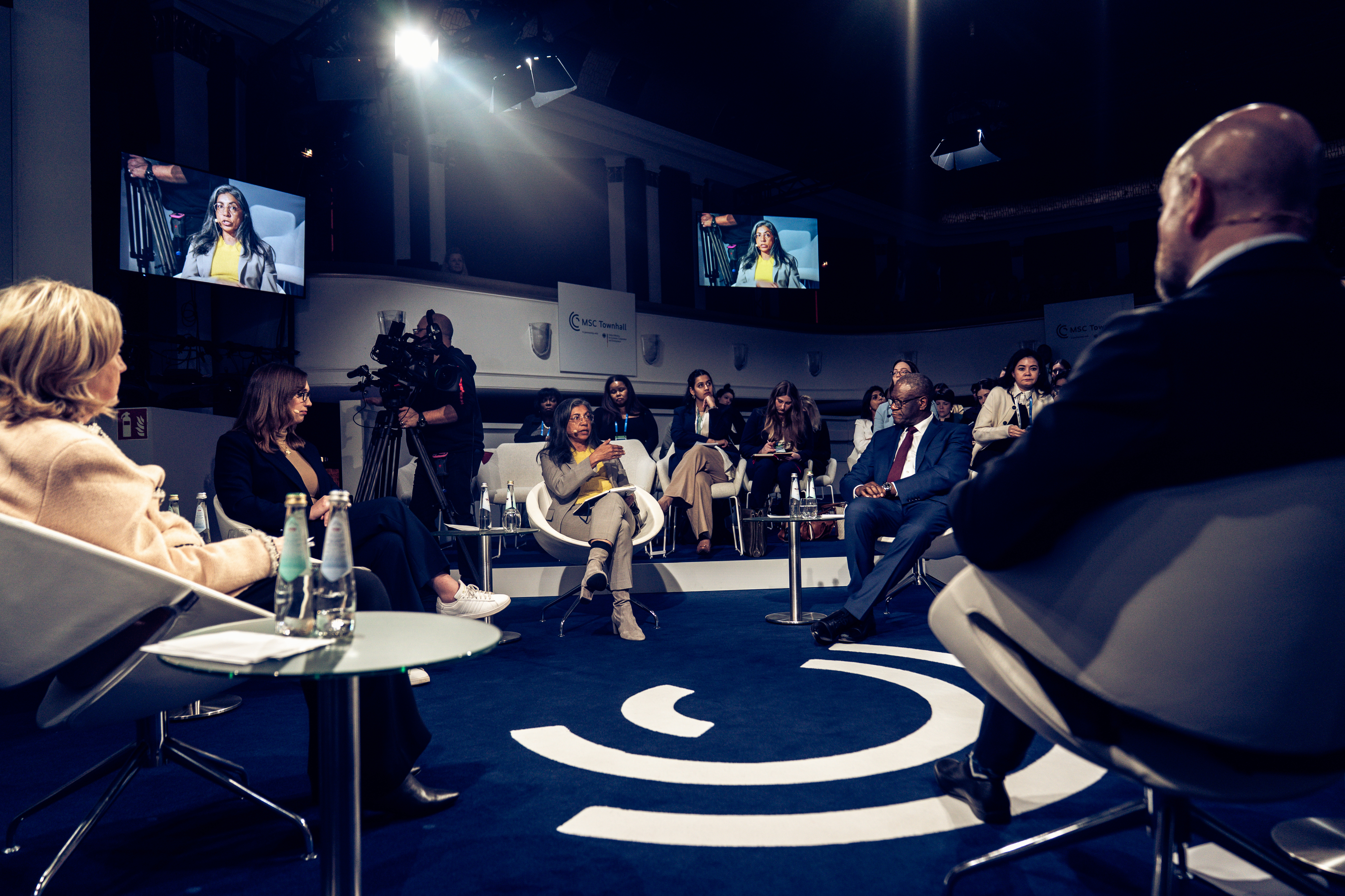 People seated at circular panel discussion
