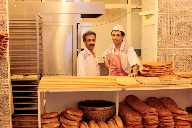 Men behind counter at bread shop