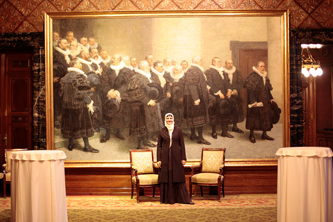 Woman standing in front of large painting