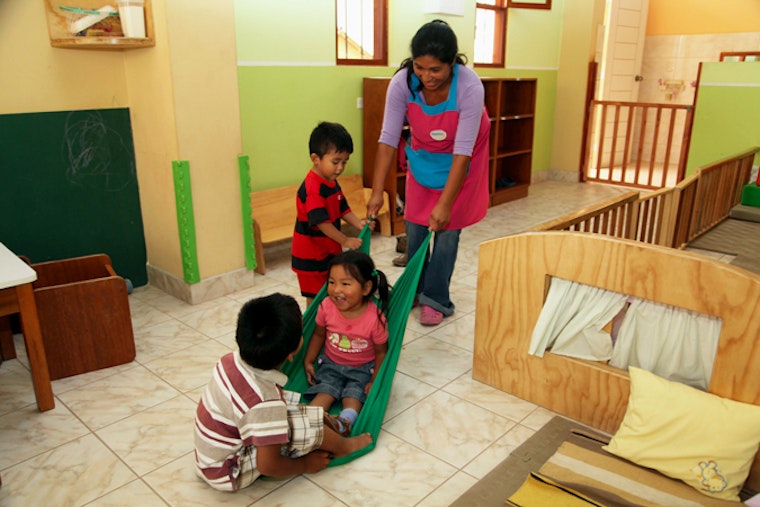 A woman playing with children