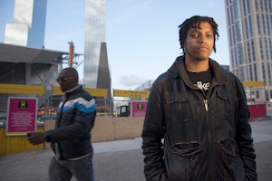 A victim of police profiling stands for a portrait in Rotterdam, the Netherlands, on May 14, 2012. Photo credit: © Ed Kashi/VII for the Open Society Foundations A man standing in a pedestrian plaza