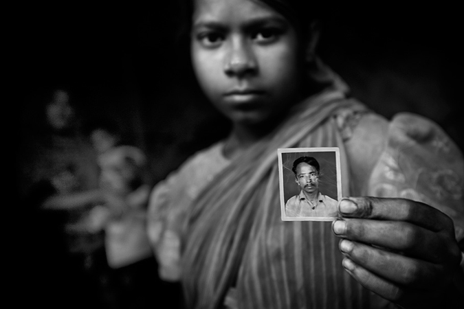 A young girl holding a picture. 