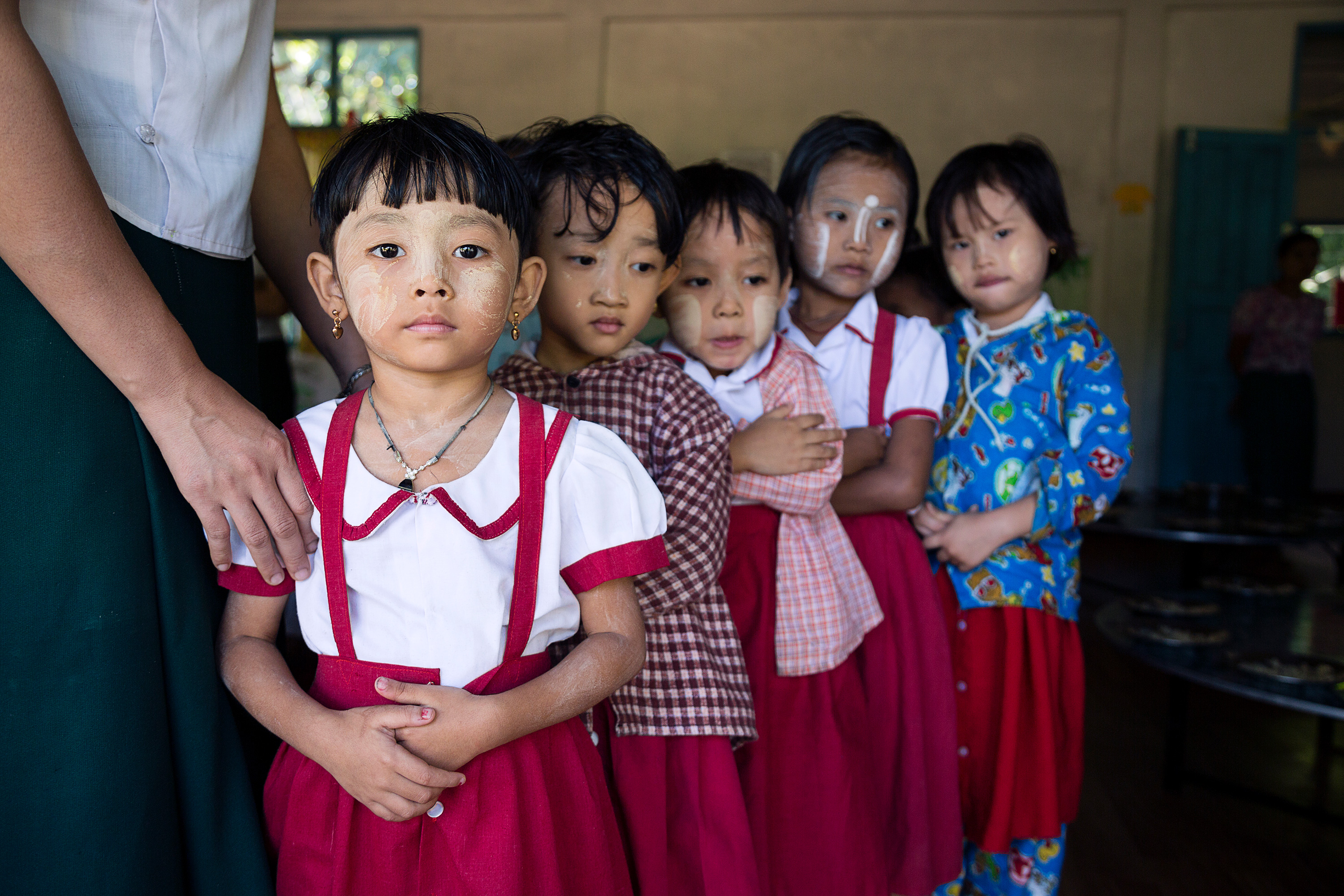 Young children standing in line.