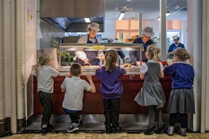 Children and staff in a cafeteria