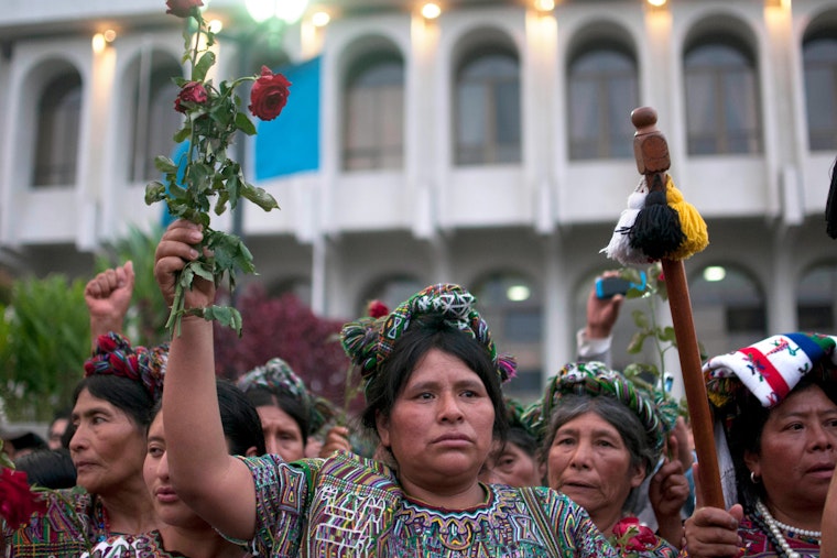 A woman stands in a crowd of other women.