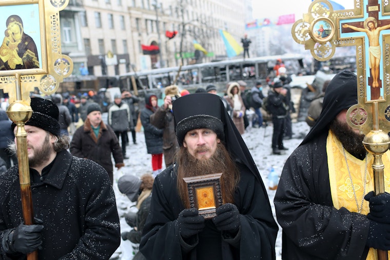 Priests holding religious objects standing